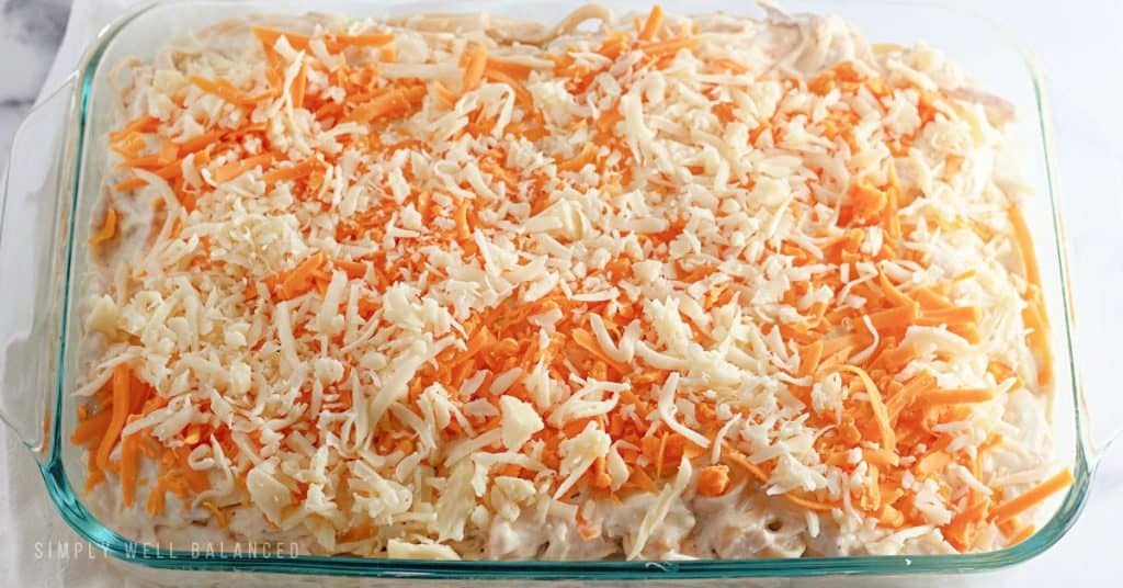 Top the casserole with shredded cheese before baking in the oven. 