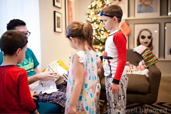 Family opening a Christmas gift together. 