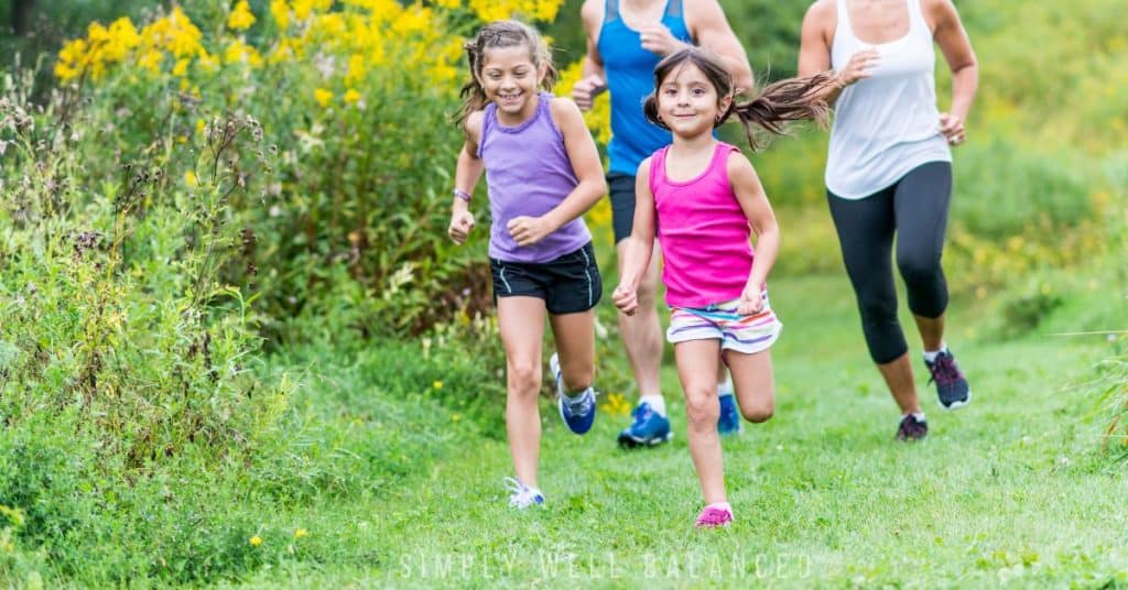 Family outside jogging together on a trail. 