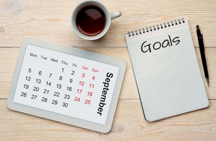 Calendar, coffee and a notebook to write down family goals. 