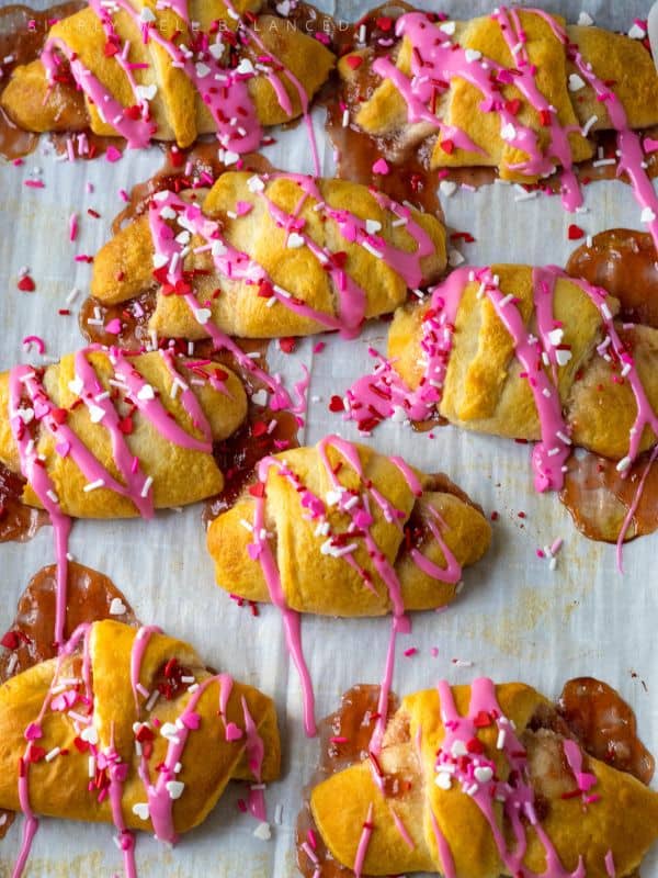 DIY Strawberry Cheesecake Crescent Rolls on parchment paper.